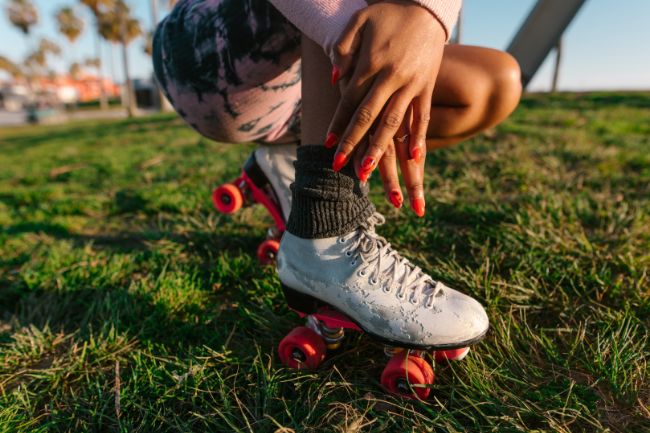 A young Woman Wearing Clean Roller Skate Wheels.